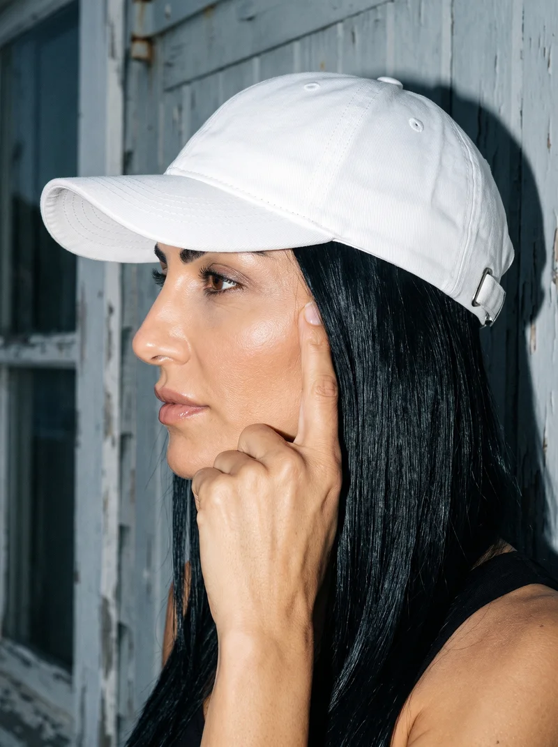Women's White Baseball Cap, Head at Side, Flash Editorial lighting