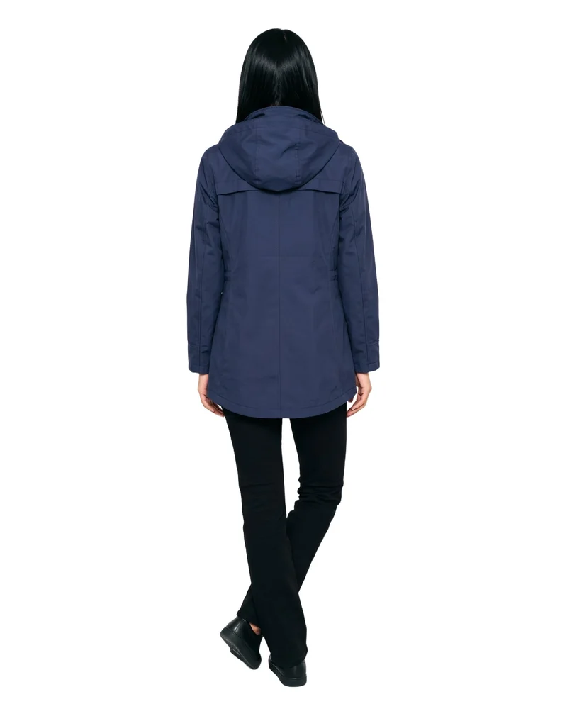 A 24-year-old Southeast Asian woman wears a women's navy waterproof raincoat in a full-body rear view, standing with her ankles crossed. The garment is shown against a pure white backdrop.