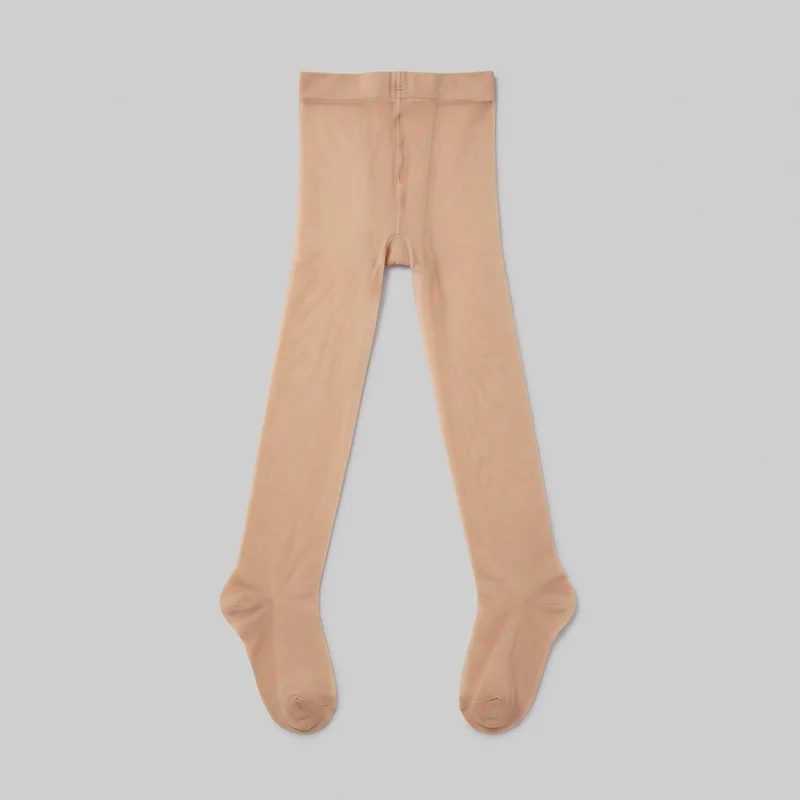 Nude sheer footed tights shown flat as a complete standalone product. The hosiery has a bodycon fit, a high-rise brief-style top with a wide stretch waistband, a horizontal seam below the waistband, a central vertical seam, and a shaped crotch gusset. Full-length narrow legs lead to enclosed shaped feet with heel areas and reinforced-looking toe seams.