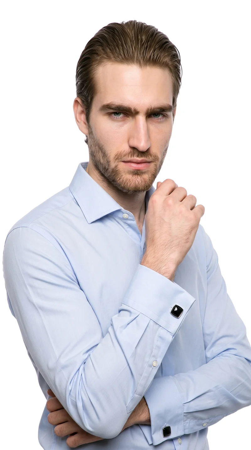 A 21-year-old Caucasian man is shown in an upper-body front three-quarter view with one hand at his chin and an intense facial expression. He wears Onyx Cufflinks, with a pure white backdrop.
