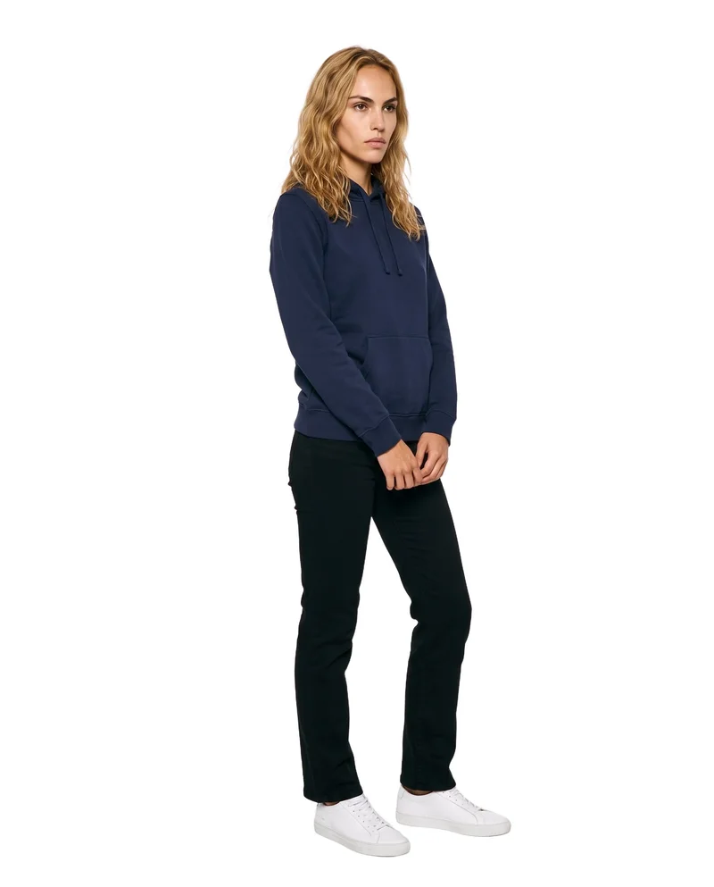 A 19-year-old Caucasian woman wears a navy cotton pullover hoodie in a full-body angled-front view, with her hands held in front and a neutral expression. The garment is shown against a pure white backdrop.