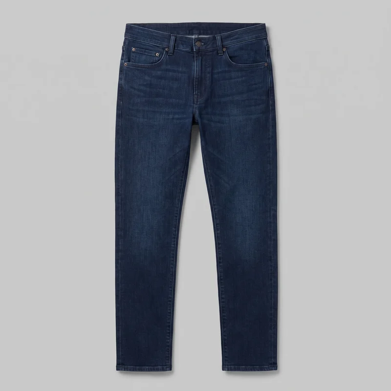 Men's indigo slim straight jeans shown in a full front flat view. The jeans have a mid-rise waistband with belt loops, a centered waist button, a fly placket, two curved front pockets with metal rivets, and a small coin pocket. Their full-length legs fit close through the hip and thigh before continuing to narrow straight hems, with visible rise stitching, side seams, inseams, and double-stitched hems.