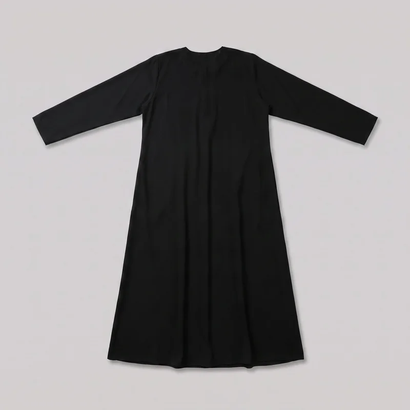 A black modest long-sleeve maxi dress is laid flat in a front-facing view. It has a simple round neckline, set-in shoulders, straight full-length sleeves, a relaxed A-line body, and a flared skirt widening to a full bottom hem. The exterior is plain, with minimal visible seaming and no visible closures, pockets, logos, prints, embroidery, or embellishments.