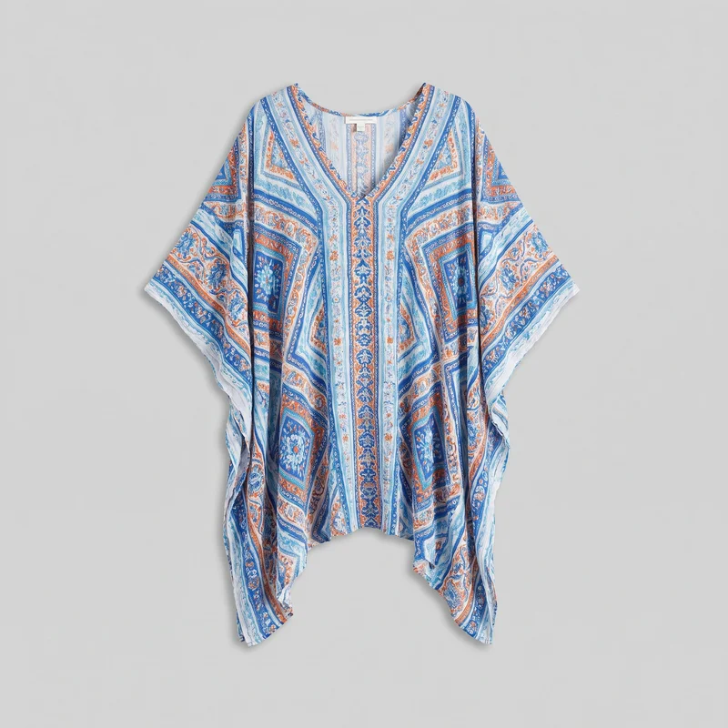 Women's printed kaftan-style cover-up shown as a standalone product view, laid or hung flat and mostly visible from the neckline to the draped hem. It has a deep V neckline, wide integrated kimono-style sleeves, a loose body, and an uneven handkerchief hem that dips at the sides. Engineered paisley and ornamental border patterns form vertical panels, diagonal neckline borders, sleeve borders, and rectangular motifs across the front.