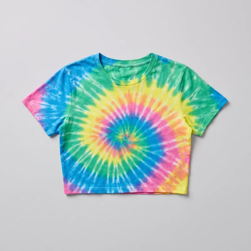 A standalone front view shows a cropped short-sleeve T-shirt with a regular boxy silhouette, crew neckline, ribbed neckband, set-in sleeves, and straight cropped hem. The shirt has visible shoulder and sleeve seams, double-row stitching at the sleeve openings and bottom hem, and an all-over spiral tie-dye pattern radiating from the lower center across the torso and sleeves. It has a clean pullover design with no closures, pockets, logos, or other visible embellishments.