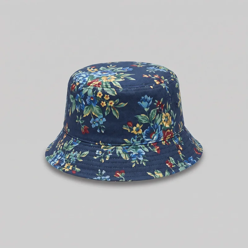 A mostly complete men's floral print bucket hat is shown as a standalone product from a slightly elevated front angle. It has a rounded flat crown, a straight cylindrical side band, a downward-sloping wraparound brim with concentric topstitching, a circular top seam, a horizontal crown seam, and side ventilation eyelets.