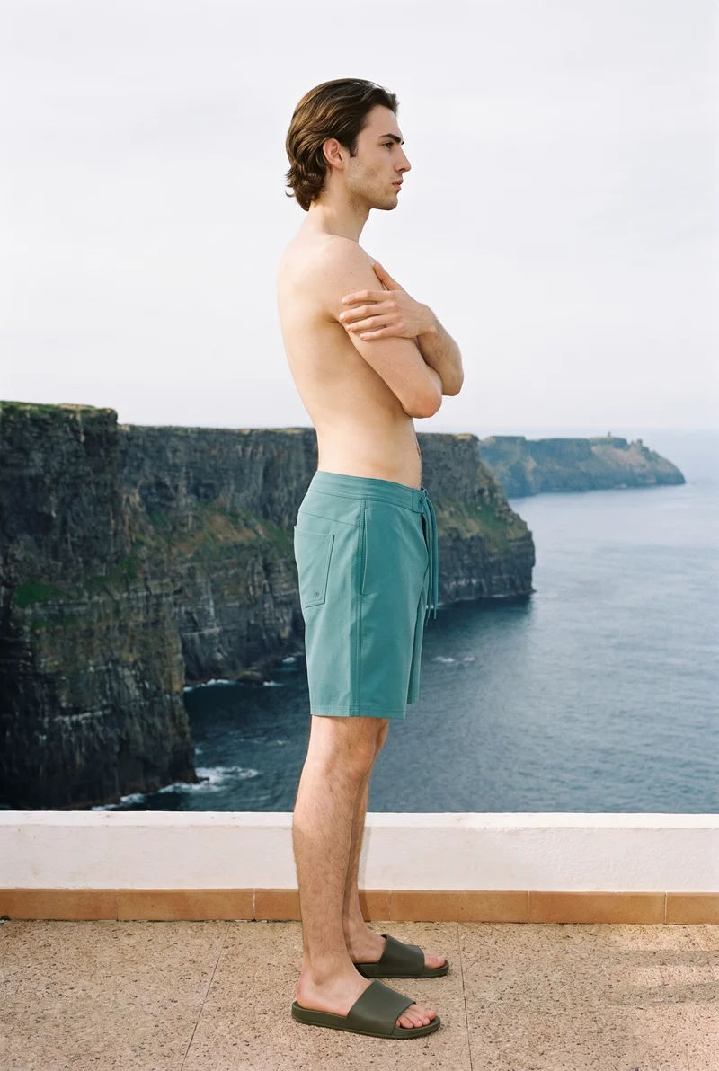 Teal Board Shorts, Full body at Side, Flash Editorial lighting