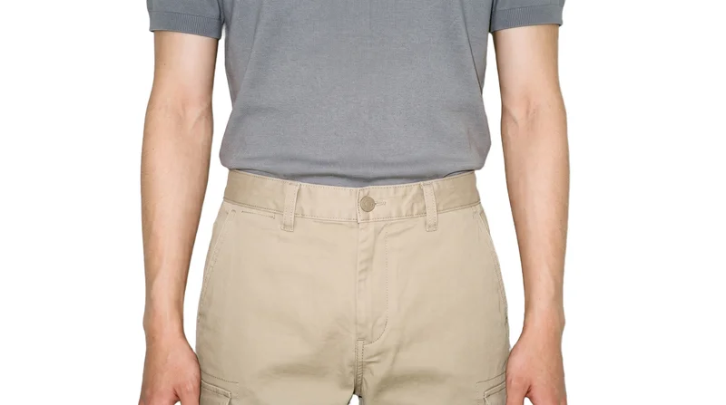 Men's khaki cargo pants shown from the front at waist level, cropped to the waistline against a pure white backdrop.