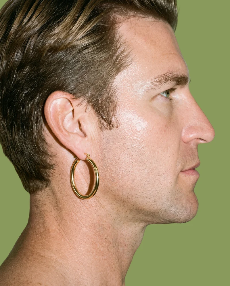 Men's Large Gold Hoop Earrings, Ear at Side, Studio Cutout lighting