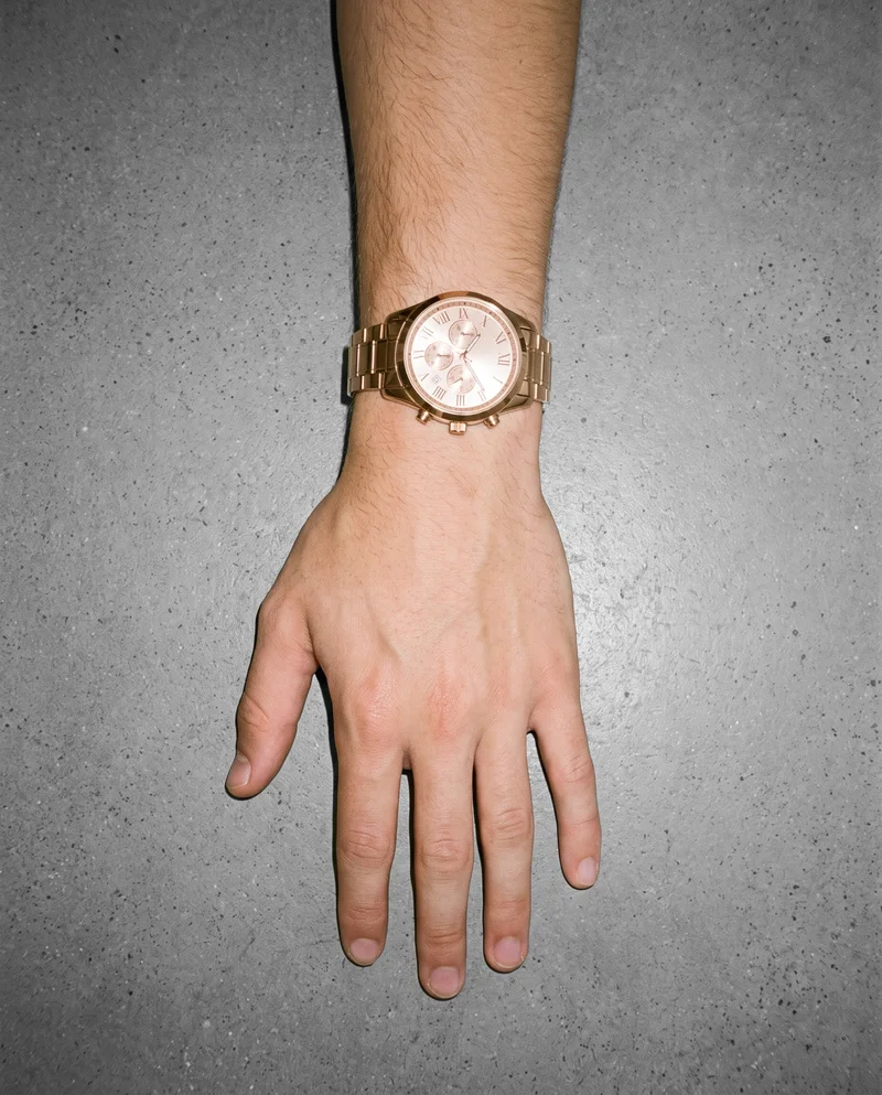 Men's Rose Gold Analogue Watch, Hand and wrist at Top, Clean Catalog lighting