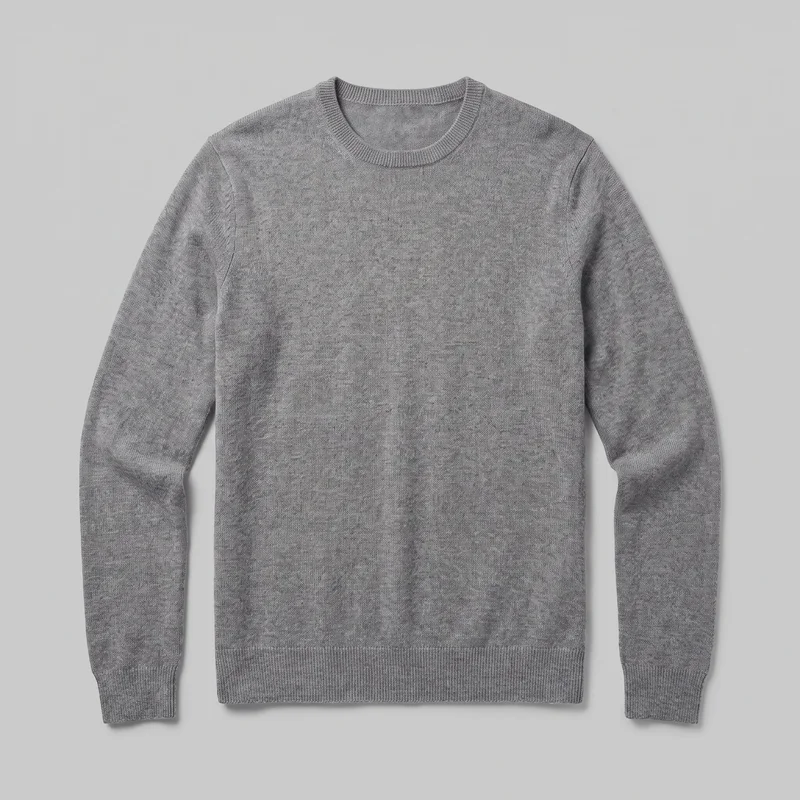 A mostly complete flat front view of a men’s grey cashmere knit pullover sweater. It has a regular fit, crew neckline, long sleeves with fitted ribbed cuffs, and a straight ribbed bottom hem. The fine, even knit surface and set-in shoulder and armhole seams are visible, with no closures, pockets, logos, prints, patches, embroidery, or embellishments.
