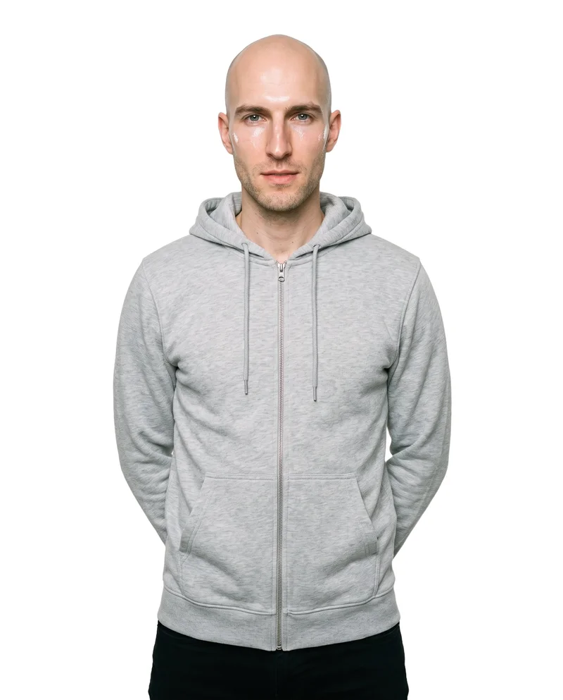 A 31-year-old Caucasian man wears a grey tracksuit top in an upper-body front view, standing with his hands behind his back and a neutral expression. The garment is shown against a pure white backdrop.