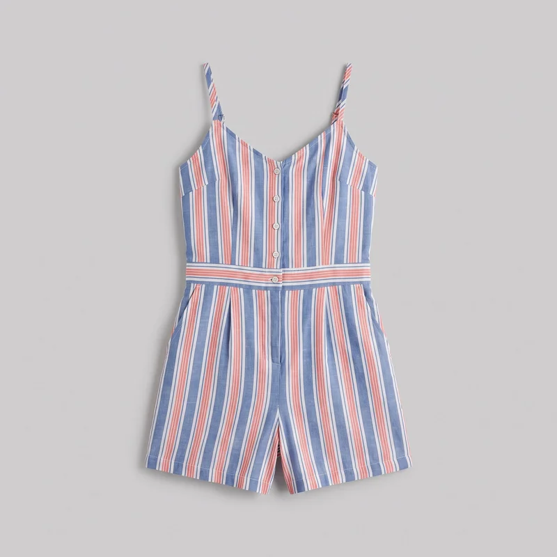 A mostly complete front view of a sleeveless striped playsuit laid flat. It has narrow shoulder straps, a V neckline, a center-front row of round buttons, a defined waistband seam, front pleats, side pocket openings, and straight hems on the loose shorts. The exterior features contrasting vertical stripes with a horizontal stripe layout across the waistband.