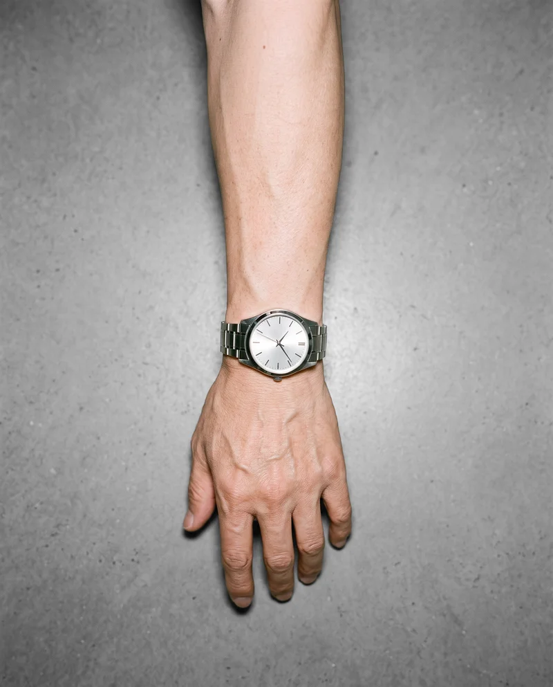 Men's Silver Dress Watch, Hand and wrist at Top, Clean Catalog lighting