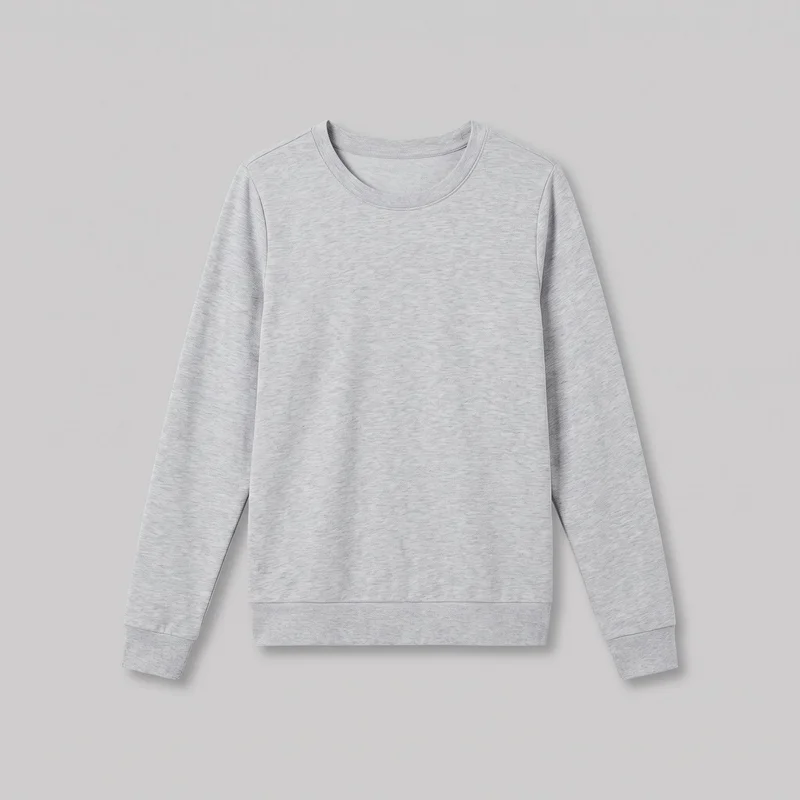 A grey women's crewneck sweatshirt is shown laid flat in a complete front view. It has a regular fit, straight body silhouette, full-length set-in sleeves, a rounded ribbed crew neckline, ribbed cuffs, and a wide ribbed hem band. The plain front has subtle heathered variation, shoulder seams, and no visible pockets, closures, logos, prints, patches, embroidery, or embellishments.