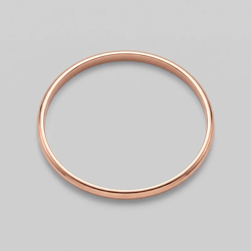 A complete rose gold bangle is shown alone from above. It has a plain circular closed-loop design, a narrow uniform band, smooth rounded outer edges, and no visible stones, engraving, logo, print, or other decoration.