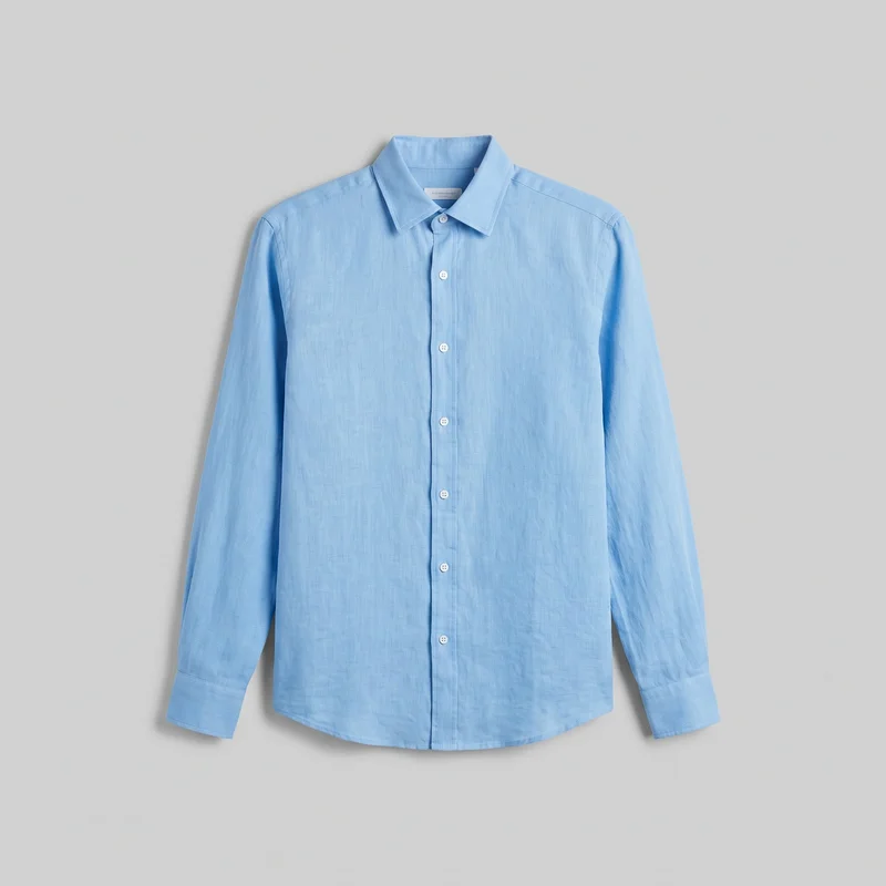 A mostly complete front view of a sky blue linen shirt displayed as a standalone product. The long-sleeve shirt has a pointed spread collar, a straight button-front placket with buttons extending from the collar to the hem, set-in sleeves with buttoned cuffs, visible shoulder and yoke seams, and a curved shirttail hem. Its regular cut and subtle woven slub texture are visible, with no chest pockets, logos, prints, patches, embroidery, or embellishments.