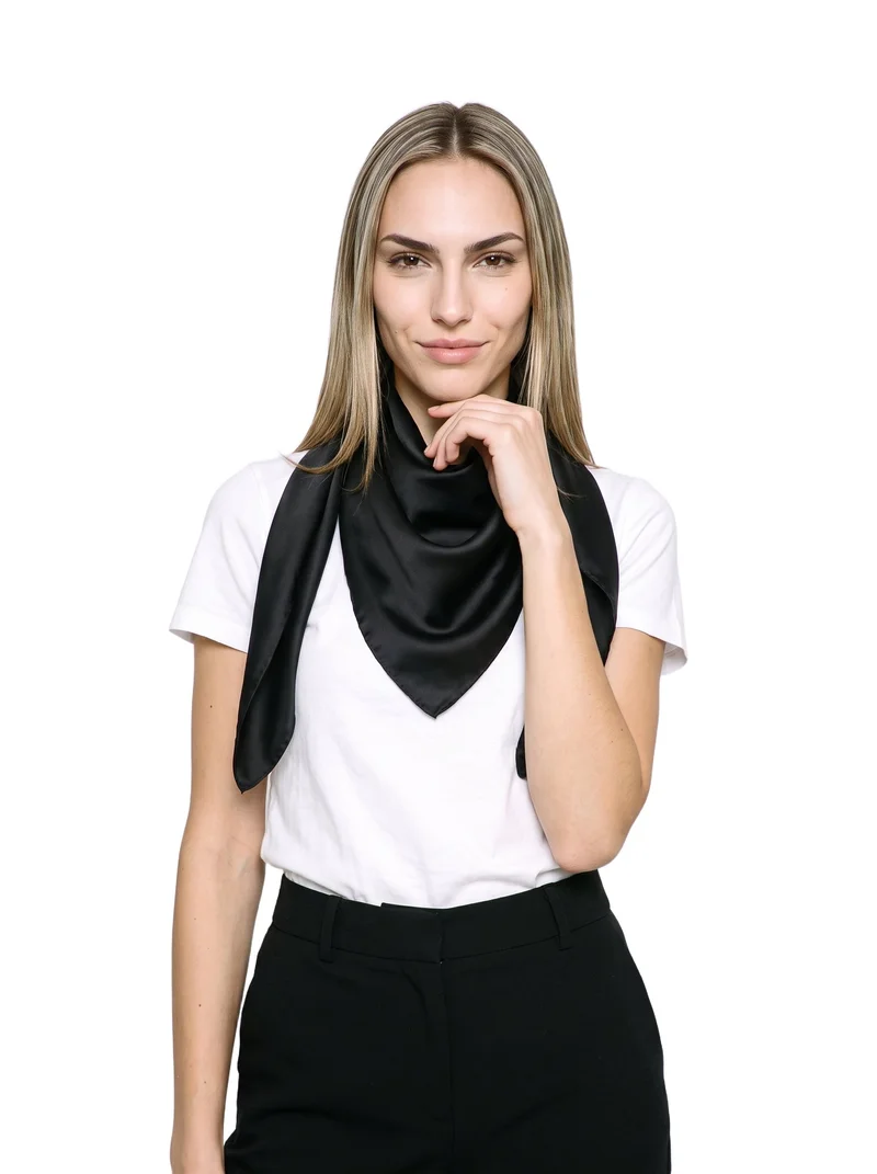 A 19-year-old Caucasian woman is shown from the upper body in a front-facing view, wearing a black silk scarf. Her wrist is positioned at her jaw, and she has a natural facial expression. The subject is isolated against a pure white backdrop.