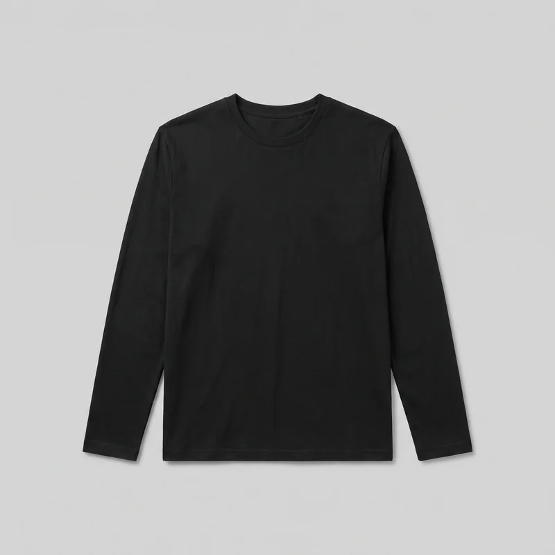 A mostly complete front view of a black regular-fit long-sleeve T-shirt laid flat against an unspecified backdrop. The shirt has a straight body, set-in shoulder seams, full-length sleeves, a round crew neckline with a narrow neckband, and a straight full-length hem. Stitched neckline, sleeve, and bottom hems are visible, with no closures, pockets, logos, prints, patches, embroidery, or embellishments.