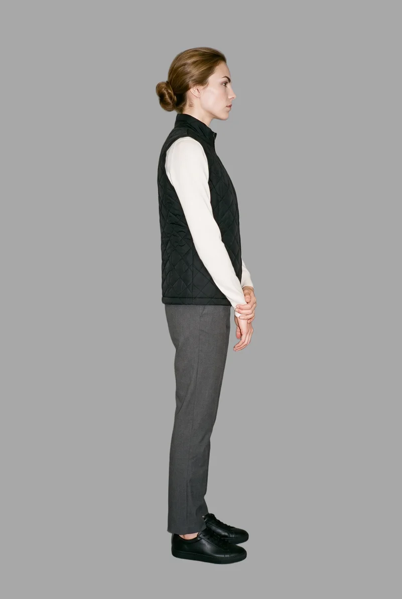 Women's Black Quilted Gilet, Full body at Side, Studio Cutout lighting