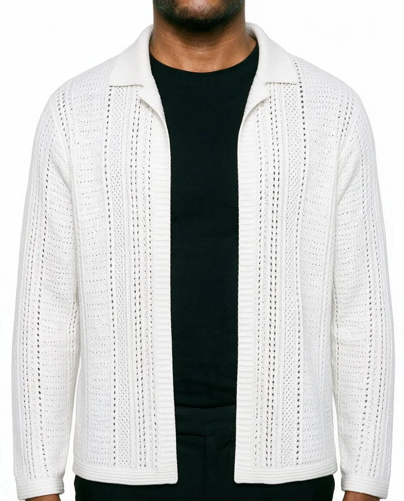 A male model is shown from the front in a torso crop wearing a white crochet cover-up, with his arms relaxed. The garment is presented against a pure white backdrop.