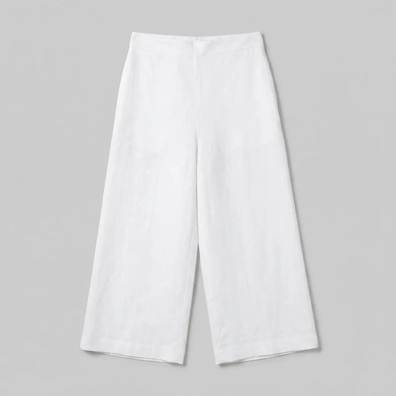 White linen women's culottes shown in a standalone front flat-lay view. The trousers have a high-rise flat waistband, a centered front fly and waist fastening area, a vertical center rise seam, relaxed wide legs, and straight calf-length hems ending well above the ankles. Inner-leg and side seams are visible, with no pockets, logos, prints, patches, embroidery, or embellishments shown.