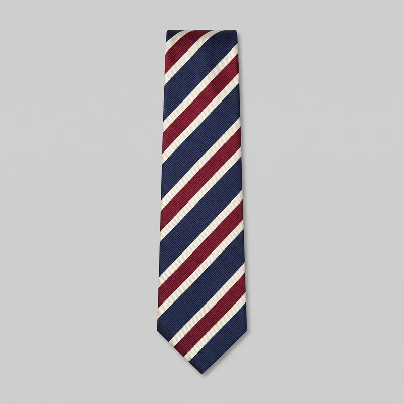 A standalone flat view shows a regular-width menswear necktie with a squared upper end, straight sides, a tapered lower section, and a pointed tip. Its woven ribbed surface carries alternating broad and narrow diagonal regimental stripes across the blade.
