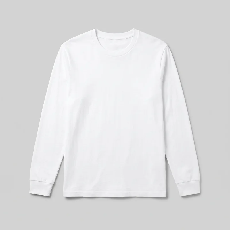 A plain white adult long-sleeve crewneck T-shirt is shown in a mostly complete front view, laid flat. The shirt has a regular straight silhouette, set-in shoulders, full-length sleeves with separate cuff bands, a rounded neckline with a narrow bound band, and a clean straight hem with visible stitching. No logos, prints, pockets, closures, patches, embroidery, or other embellishments are visible.