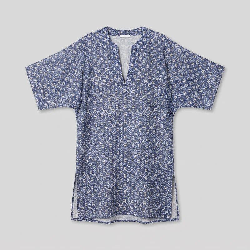 A mostly complete flat view of a men's printed kaftan cover-up. The relaxed tunic has an elongated straight body, a collarless round neckline with a deep center-front V-notch, extended drop shoulders, and wide short dolman-style sleeves. Its loose rectangular silhouette includes visible side seams, side hem slits, and a straight edged bottom hem, all covered by a repeating floral and diamond geometric print.