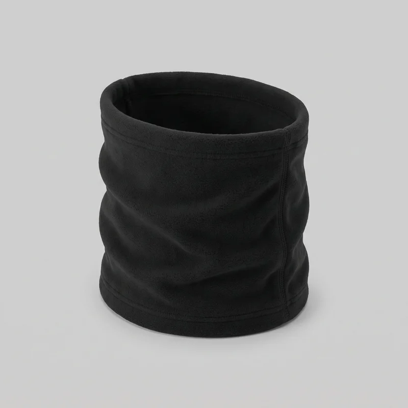 A black fleece neck gaiter stands upright as a continuous cylindrical tube with open top and bottom edges. The soft textured exterior, stitched bands around both edges, and vertical side seam with parallel stitching are visible; no logos, prints, patches, embroidery, or embellishments are shown.