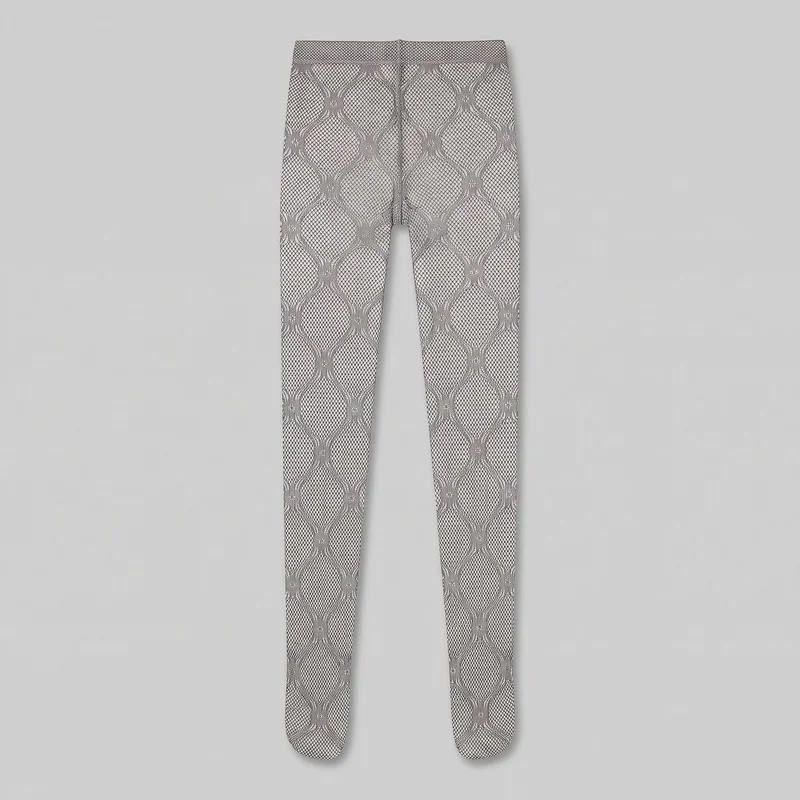 Complete flat view of full-length footed tights with a high-rise waist, wide waistband, narrow legs, and enclosed rounded feet. An all-over diamond fishnet ground is overlaid with a larger repeating ogee and scroll lattice motif running vertically down both legs, with a center seam visible from the waistband through the crotch area.
