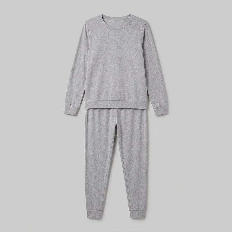 A matching grey marl pyjama set is shown laid together in a front-facing standalone view. The set includes a regular-fit crewneck sweatshirt with a ribbed round neckline, long sleeves, ribbed cuffs, a straight ribbed hem, and a plain front, paired with tapered jogger pants featuring visible inner leg seams and ribbed ankle cuffs. The sweatshirt covers most of the pull-on waistband, while the trousers are visible from below the waistband to the cuffs.