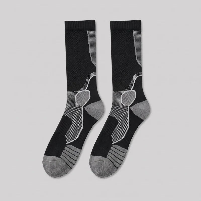 A matching pair of men’s technical compression sports socks is laid flat, with the full straight tubular legs, ribbed top cuffs, shaped heels, fitted feet, and rounded toes visible. The socks feature engineered knit panels, ribbed bands across the forefoot, dotted curved panels from the ankles up the sides of the legs, and contrasting reinforced toe and heel areas. No logos, text, or branding are visible.