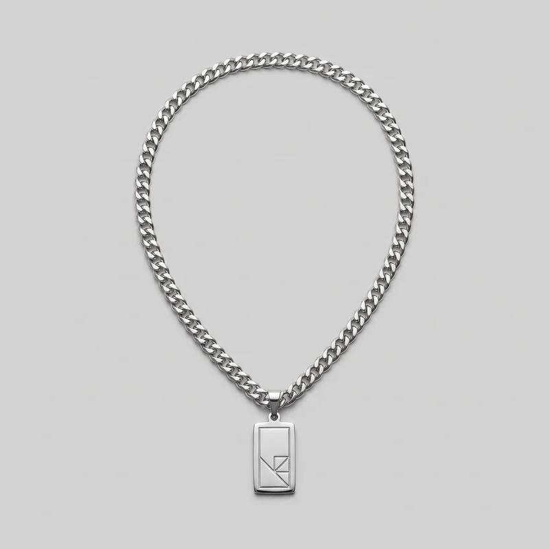 A standalone silver pendant necklace is arranged in an oval, with a centered vertical rectangular dog-tag style pendant at the bottom. The necklace has flat, tightly interlocking curb links, a tapered bail, and a small connector ring. The pendant features a raised outer border, an inset rectangular panel, and an angular geometric line motif across its lower portion, with no visible text or logos.