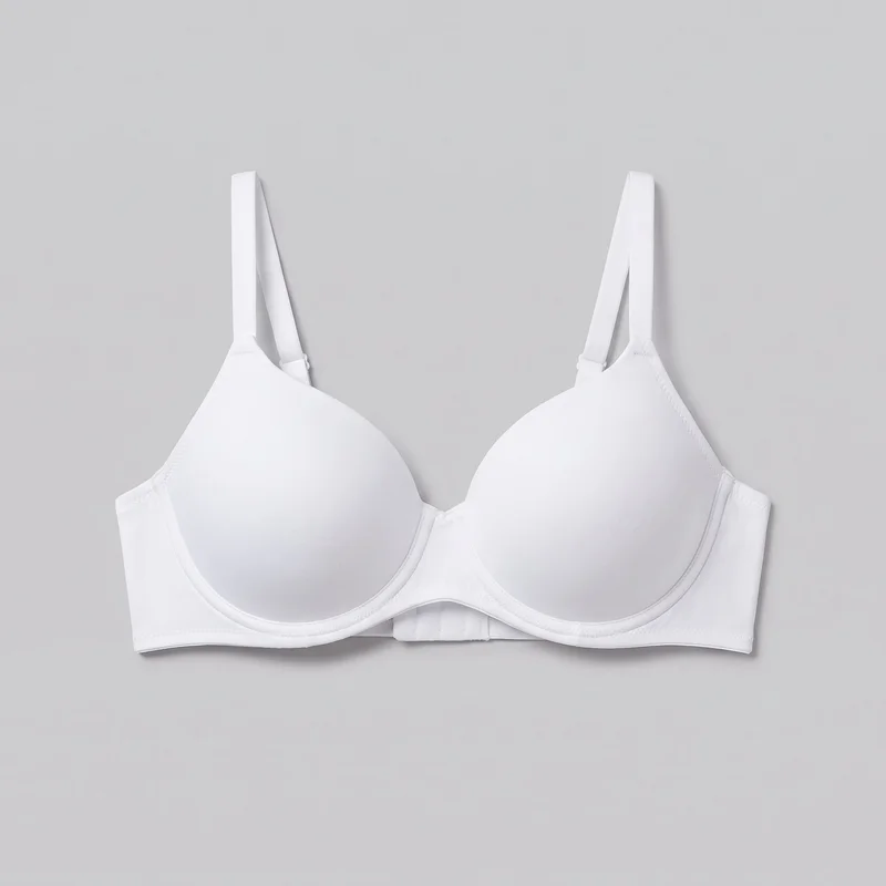 A mostly complete front view of a white women's molded underwire bra laid flat. It has two smooth rounded cups, a low center gore, a straight lower band, visible underwire channeling, narrow bound edges, stitched cup-perimeter and side-join details, side wings, and adjustable shoulder straps with visible sliders. The exterior is plain, without visible logos, prints, patches, embroidery, or embellishments.