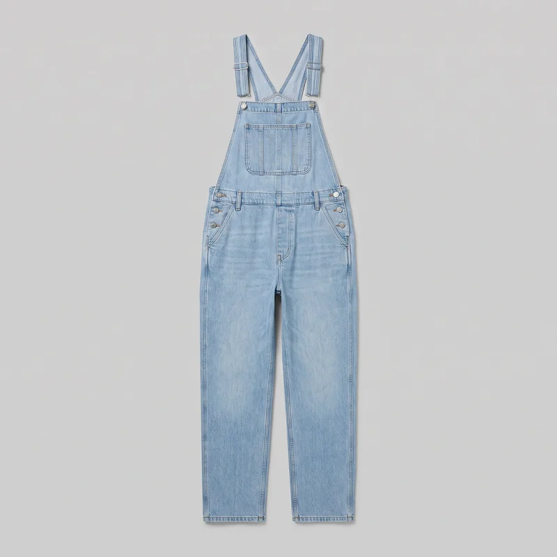 Light wash denim bib overalls are shown in a complete front flat-lay view, with crossed adjustable shoulder straps extending above the square bib. The design includes a divided front bib pocket, side button closures, curved hip pockets, belt loops, a fly outline, contrast topstitching, and full straight legs ending in straight hems.