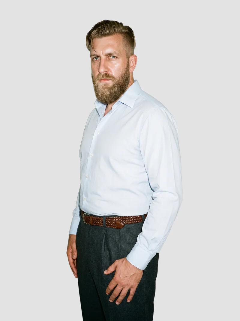 A 43-year-old Slavic man is shown from a three-quarter length front angle with a waist twist and a serious expression, wearing a brown braided belt. A fog-grey flat-color backdrop surrounds the figure.