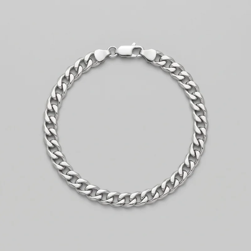 A silver Cuban link chain bracelet is laid in an oval loop as a standalone product view. The bracelet features broad, flattened interlocking links with rounded edges, polished top surfaces, recessed inner openings, and a rectangular box clasp visible at the top with adjacent end links and a small circular connector ring.