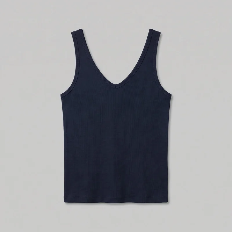 A navy sleeveless tank top is shown in a full flat product view. It has a V neckline, wide shoulder straps, low curved armholes, a slim straight silhouette, narrow vertical ribbing, bound neckline and armhole trim, visible edge stitching, side seams, and a straight bottom hem.