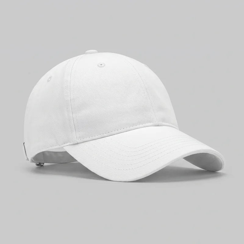 A white women's baseball cap is shown alone in a three-quarter view. The cap has a rounded six-panel crown with vertical seams, embroidered ventilation eyelets, a covered top button, and a curved forward brim with parallel rows of topstitching and a bound edge. Part of the rear adjustable strap and its metal slider hardware is visible; no logos, prints, patches, embroidery, or other embellishments are shown.