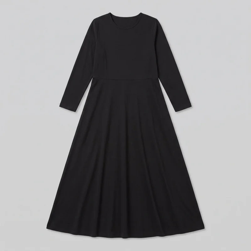 A mostly complete front flat-lay view shows a black modest maxi dress with a rounded crew neckline, long sleeves with straight hems, and a horizontal waist seam. The bodice has a regular fit, while the skirt flares away from the waist to a full-length, even wide hem. No closures, pockets, logos, prints, embroidery, patches, or embellishments are visible.