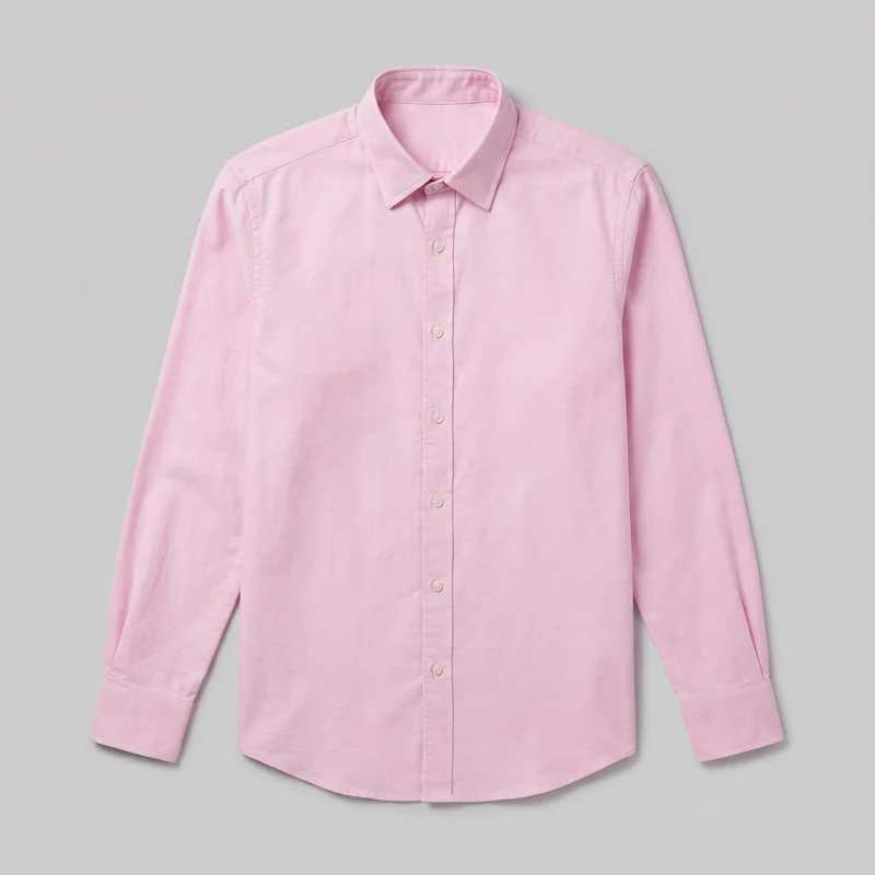 A pink long-sleeve Oxford shirt is laid flat in a centered standalone front view. It has a regular straight-cut silhouette, pointed fold-down collar, full button placket, set-in shoulders, visible yoke and shoulder seams, simple barrel cuffs, narrow topstitching, and a gently curved shirttail hem. The front is pocketless and has no visible logos, prints, patches, embroidery, or embellishments.