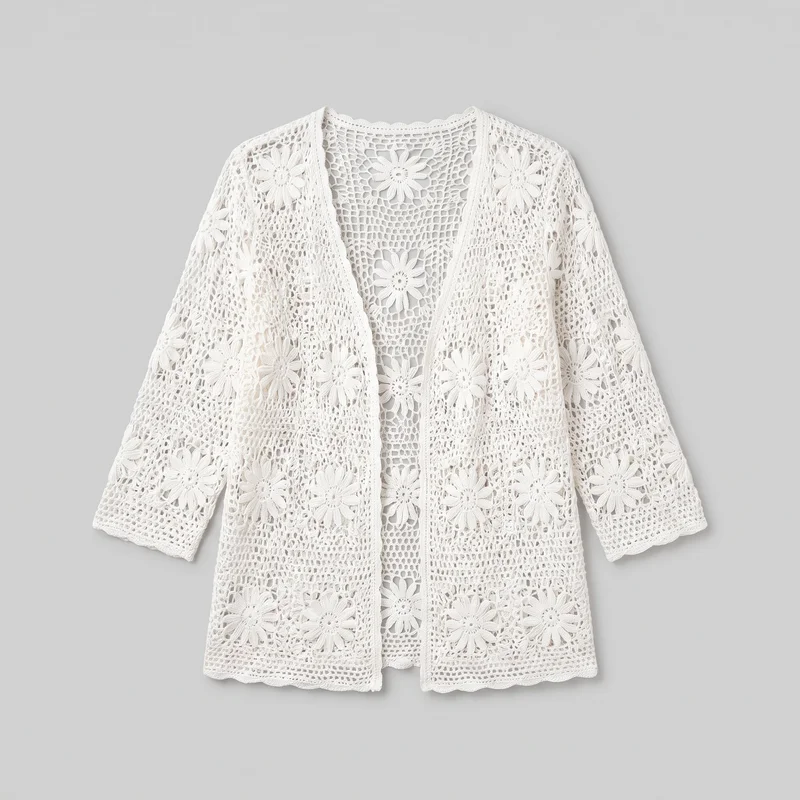 A mostly complete standalone view of a women's white crochet cover-up cardigan, shown flat with its open front, deep V-shaped opening, rounded back neckline, dropped shoulders, long wide sleeves, straight lower hem, and elongated relaxed silhouette visible. Repeated daisy floral motifs form an all-over open lattice pattern across the front panels, back, and sleeves, with scalloped crochet edging along the neckline, cuffs, front opening, and hem.