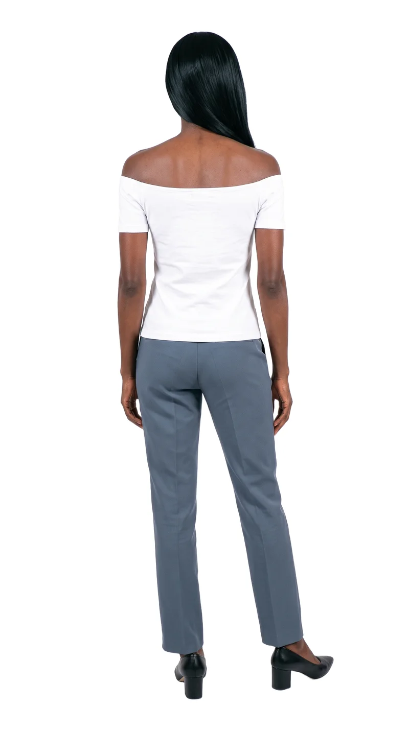 A 28-year-old African woman stands in a relaxed pose, shown full body from the back, wearing a white cotton Bardot top. The garment is presented against a pure white backdrop.