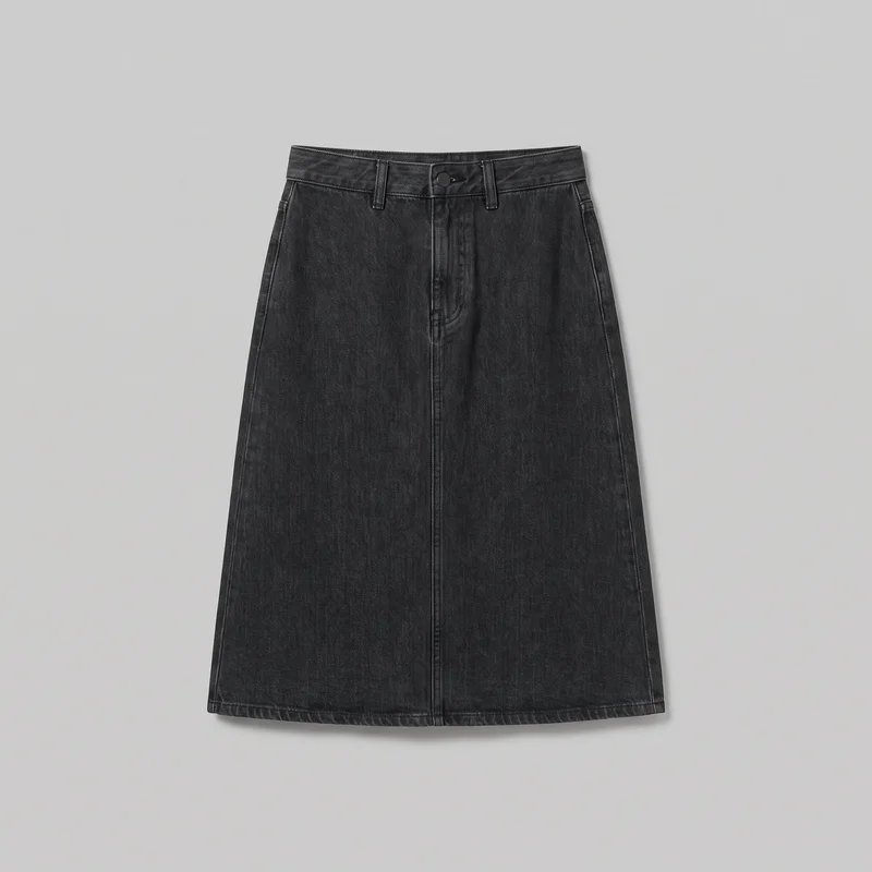 A black A-line denim skirt is shown laid flat in a full front view. It has a structured waistband with multiple belt loops, a centered front fly with one visible waistband button, vertical center-front seaming, angled pocket openings on both sides, side seams, and a stitched straight hem at below-knee to midi length.