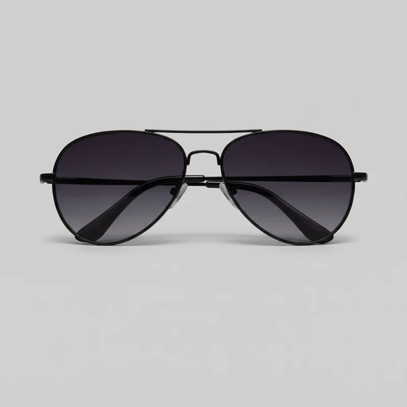 Black aviator sunglasses shown in a standalone front view. The eyewear has rounded teardrop-shaped gradient-tinted lenses in a thin full-rim frame, with a straight upper brow bar, arched nose bridge, clear adjustable nose pads, slim temples, and curved temple tips visible through the lenses.