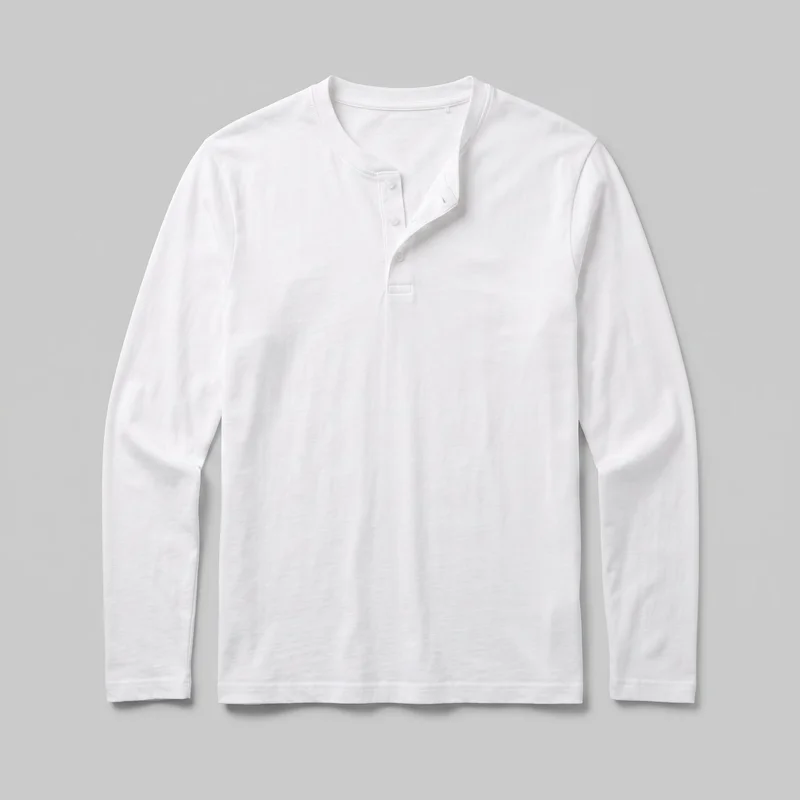 A mostly complete front view of a white regular-fit long-sleeve henley shirt laid flat against a backdrop. It has a rounded crew neckline, a partial front placket with several buttons left open near the neck, set-in shoulders, straight sleeves, a straight body, and a visible stitched bottom hem. No pockets, logos, prints, patches, embroidery, or embellishments are visible.