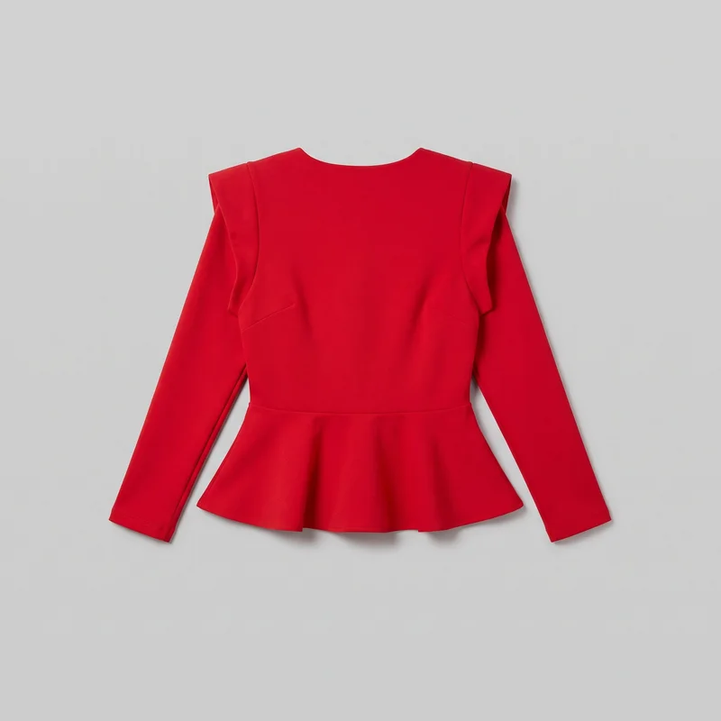 A red women's peplum top is shown in a flat-lay view. It has a shallow round neckline, fitted long sleeves, structured layered shoulder ruffle panels, a horizontal waist seam, and a flared peplum hem.