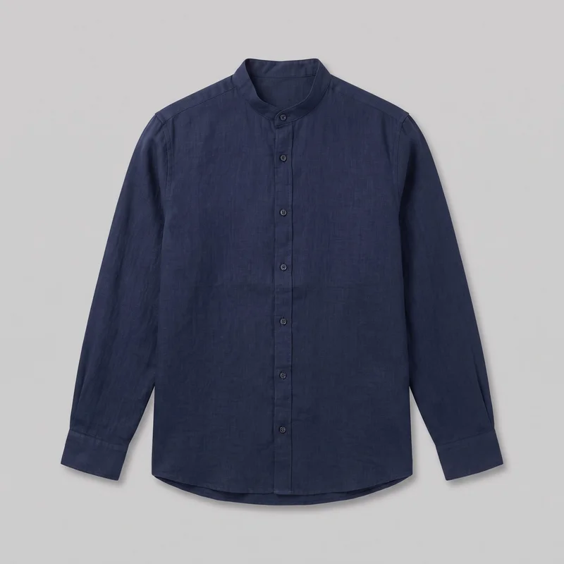 A standalone front view of a navy linen grandad shirt with a regular fit, straight body, band collar, centered button placket, long sleeves, buttoned cuffs, and a gently curved shirttail hem. The shirt has set-in shoulders, visible seam lines, round buttons extending from the collar through the body, and no visible chest pocket or embellishment.