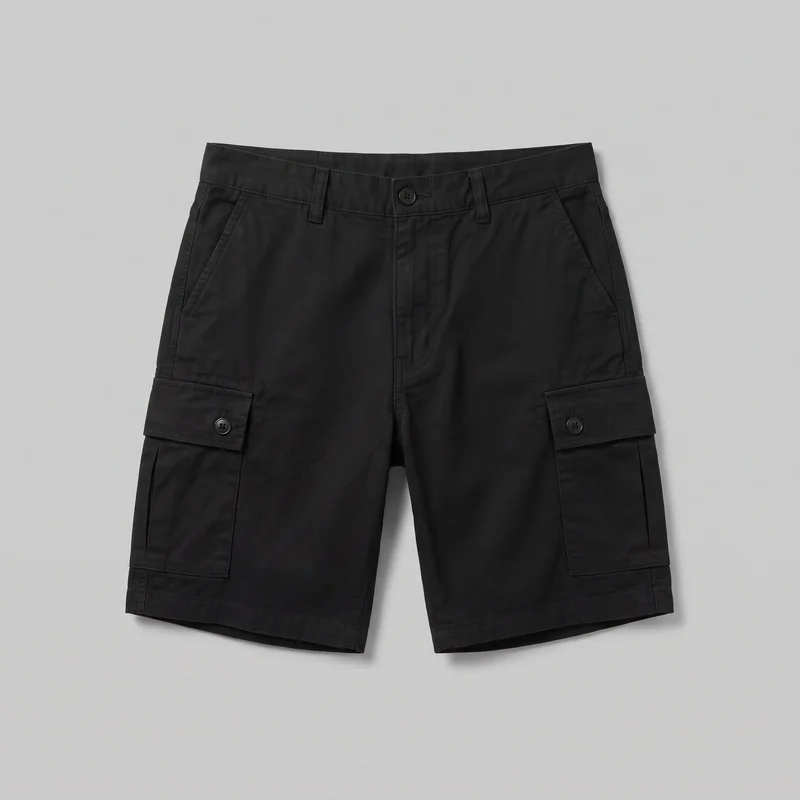 Men’s black cargo shorts laid flat in a complete front view. They have a structured waistband with belt loops and a single center button, a fly placket, two slanted hip pockets, and straight above-knee legs with straight hems. Each outer thigh has a rectangular flap cargo pocket secured with a button, with visible stitched pocket edges and hem topstitching.